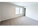 Bright bedroom features neutral carpet, fresh paint, and double windows for plenty of natural light at 5547 Bent Grass Way, Douglasville, GA 30135