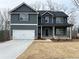 Charming two-story home with a two-car garage, inviting porch, and craftsman-style details at 5547 Bent Grass Way, Douglasville, GA 30135