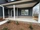 Inviting front porch with brick accents and classic columns, perfect for relaxing outdoors at 5547 Bent Grass Way, Douglasville, GA 30135