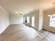 Open living room featuring wood floors, ceiling fan, fireplace, and deck access at 5547 Bent Grass Way, Douglasville, GA 30135