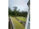 View of the expansive, grassy backyard with a wooden fence and mature trees at 582 Georgia Cir, Loganville, GA 30052