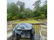 Outdoor deck area overlooking a large fenced backyard and trees at 582 Georgia Cir, Loganville, GA 30052