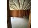 Unfinished basement with wooden studs and insulation for a customizable space at 582 Georgia Cir, Loganville, GA 30052