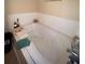 Close up of whirlpool bathtub with tile surround at 582 Georgia Cir, Loganville, GA 30052