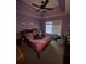Cozy bedroom featuring light purple walls, ceiling fan, and window for natural light at 582 Georgia Cir, Loganville, GA 30052