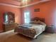 Spacious primary bedroom features a large window with a tray ceiling and an ensuite bathroom at 582 Georgia Cir, Loganville, GA 30052