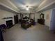 Spacious bedroom with tray ceiling, fireplace, and dark wood furniture at 582 Georgia Cir, Loganville, GA 30052