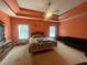Spacious primary bedroom features a large window with a tray ceiling and an ensuite bathroom at 582 Georgia Cir, Loganville, GA 30052