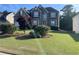 Charming two-story home with landscaped yard and brick and stone exterior, perfect for curb appeal at 582 Georgia Cir, Loganville, GA 30052