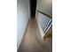 Carpeted hallway with railing on the stairwell at 582 Georgia Cir, Loganville, GA 30052