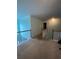 Upstairs hallway featuring neutral carpet and white railing at 582 Georgia Cir, Loganville, GA 30052