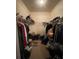 Walk-in closet with wire shelving, carpet flooring and disorganized storage at 582 Georgia Cir, Loganville, GA 30052