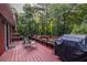 Back deck featuring outdoor seating, grill, and wooded views at 1102 Waverly Dr, Lawrenceville, GA 30046