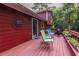 Back deck featuring outdoor seating, potted plants, and wooded scenery at 1102 Waverly Dr, Lawrenceville, GA 30046