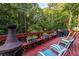 Outdoor deck with patio furniture, grill, and a peaceful, wooded backdrop at 1102 Waverly Dr, Lawrenceville, GA 30046