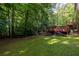 Expansive backyard with a spacious wooden deck, surrounded by lush greenery and mature trees at 1102 Waverly Dr, Lawrenceville, GA 30046