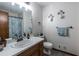 Bathroom featuring a single sink vanity, toilet, and decorative wall art at 1102 Waverly Dr, Lawrenceville, GA 30046