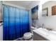 Well-lit bathroom with blue shower curtain and modern fixtures at 1102 Waverly Dr, Lawrenceville, GA 30046