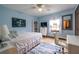 Well-lit bedroom with light blue walls, ceiling fan, and white furnishings at 1102 Waverly Dr, Lawrenceville, GA 30046