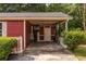 The red home has a convenient carport and adjacent storage space, adding functionality at 1102 Waverly Dr, Lawrenceville, GA 30046