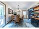 Charming dining area with a wooden table, chandelier lighting, and bar area at 1102 Waverly Dr, Lawrenceville, GA 30046