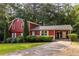 Inviting two-story home with manicured lawn, carport, and beautiful mature trees at 1102 Waverly Dr, Lawrenceville, GA 30046