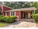 Charming red home with a carport, tidy landscaping, and a well-maintained facade at 1102 Waverly Dr, Lawrenceville, GA 30046