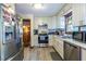 Modern kitchen featuring stainless steel appliances, white cabinets, and durable grey flooring at 1102 Waverly Dr, Lawrenceville, GA 30046