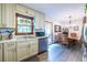 Bright kitchen with stainless appliances, white cabinets, and view to adjacent dining area at 1102 Waverly Dr, Lawrenceville, GA 30046