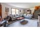 Bright living room with neutral walls, plush grey carpeting, and comfortable sofas flanking a staircase at 1102 Waverly Dr, Lawrenceville, GA 30046