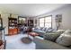Comfortable living room featuring plush grey sofas, carpeted floors, and classic wooden cabinets at 1102 Waverly Dr, Lawrenceville, GA 30046