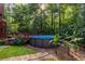 Backyard oasis with an above-ground pool, wooden deck, and lush greenery, perfect for summer fun at 1102 Waverly Dr, Lawrenceville, GA 30046