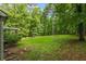 Expansive backyard featuring lush greenery, mature trees, and space for outdoor activities at 1154 Pinebrook Rd, Auburn, GA 30011