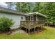 Backyard view with the house screened in deck and stairs at 1154 Pinebrook Rd, Auburn, GA 30011
