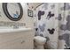 Bathroom with white vanity, tiled backsplash, Mickey Mouse decor, and patterned shower curtain at 1154 Pinebrook Rd, Auburn, GA 30011