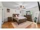 Spacious bedroom with a ceiling fan, window and a large wooden dresser at 1154 Pinebrook Rd, Auburn, GA 30011