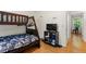 Bedroom featuring a wooden bunk bed, television, and hardwood floors at 1154 Pinebrook Rd, Auburn, GA 30011