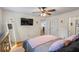 Spacious bedroom with a ceiling fan, tv, and hardwood floors at 1154 Pinebrook Rd, Auburn, GA 30011