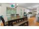 Bright dining area with a wooden table, bench seating, and large window at 1154 Pinebrook Rd, Auburn, GA 30011