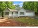 Charming single-story home with a white picket deck, an attached garage, and surrounded by lush greenery at 1154 Pinebrook Rd, Auburn, GA 30011
