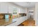 Bright kitchen with stainless steel sink and granite countertops with backsplash at 1154 Pinebrook Rd, Auburn, GA 30011
