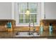 Close up of stainless steel sink, window, granite countertops, and stainless fixtures at 1154 Pinebrook Rd, Auburn, GA 30011