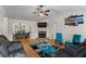 Inviting living room featuring a stone fireplace, wood floors, and modern furnishings at 1154 Pinebrook Rd, Auburn, GA 30011