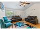 Bright living room featuring wood floors, a ceiling fan, and comfortable seating at 1154 Pinebrook Rd, Auburn, GA 30011