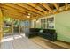 Screened porch with comfortable seating and a ceiling fan at 1154 Pinebrook Rd, Auburn, GA 30011