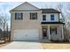 Charming two-story home featuring a two-car garage, light brick facade, and stylish black shutters at 18 Loth Wages (Lot 18) Rd, Dacula, GA 30019