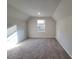 Bonus room with neutral carpet, natural light, and storage access at 28 Loth Wages (Lot 28) Rd, Dacula, GA 30019