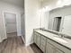 Bright bathroom featuring a double vanity, glass shower, and walk-in closet access at 5295 Greenway Dr, Villa Rica, GA 30180