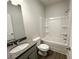 Bathroom featuring a shower-tub combo, modern fixtures, granite countertop, and a wood look floor at 5295 Greenway Dr, Villa Rica, GA 30180