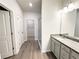 Bright bathroom featuring a vanity, glass shower, and walk-in closet access at 5295 Greenway Dr, Villa Rica, GA 30180